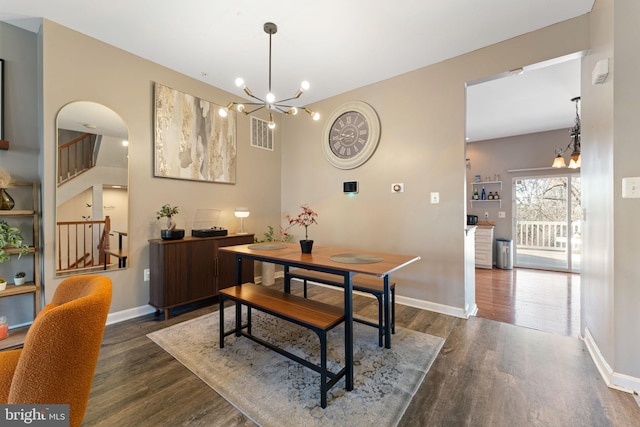 dining area with visible vents, baseboards, an inviting chandelier, and dark wood-style flooring