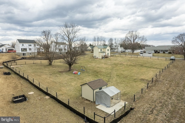 view of yard with a residential view, fence, and an outdoor structure