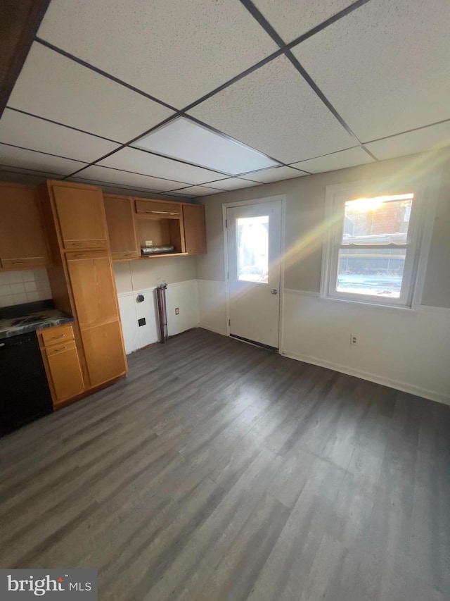 kitchen featuring dark wood-style floors, a paneled ceiling, and brown cabinets