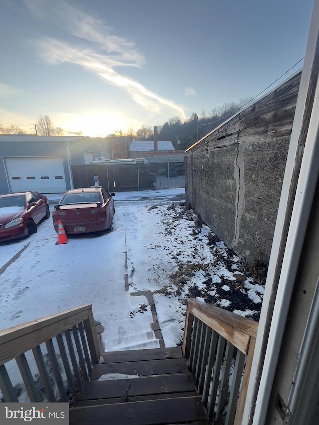 yard layered in snow with fence