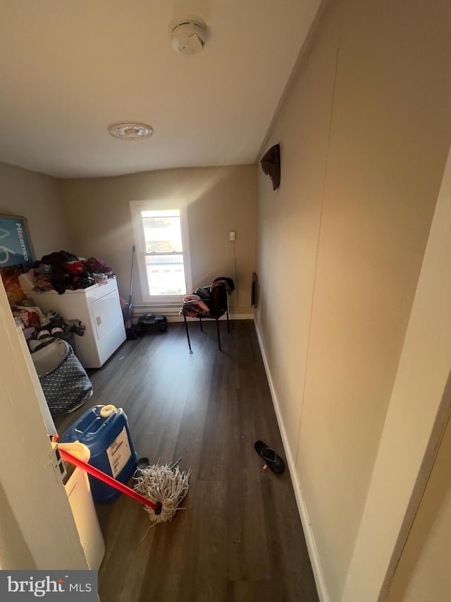 washroom featuring laundry area, dark wood finished floors, and baseboards