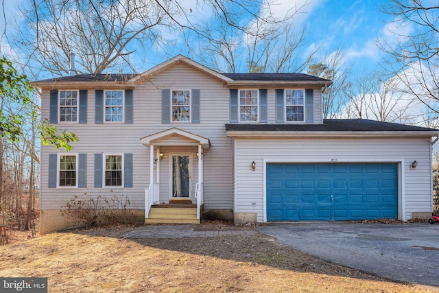 colonial-style house with driveway and a garage