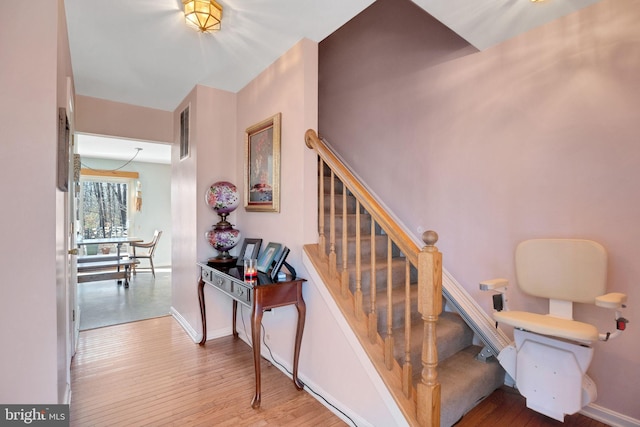 stairs featuring visible vents, baseboards, and wood finished floors