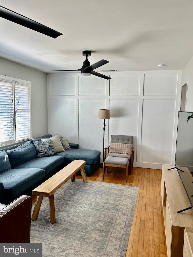 living area featuring a ceiling fan and light wood-style floors