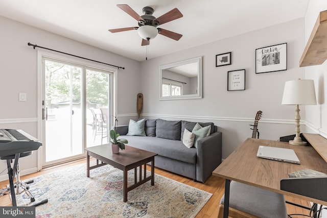 living room featuring light wood finished floors and ceiling fan