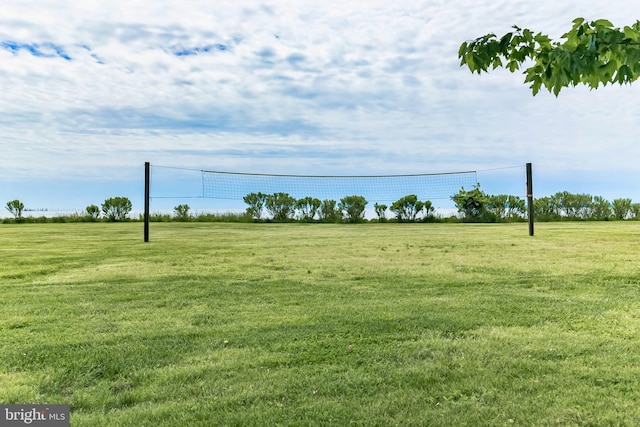 surrounding community with volleyball court and a yard