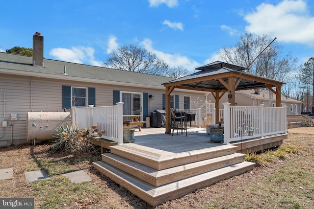 wooden terrace featuring a gazebo