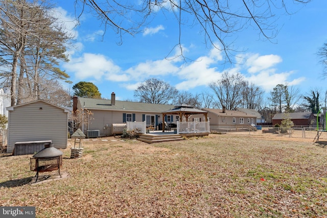 back of house with a yard, a wooden deck, fence, and a gazebo