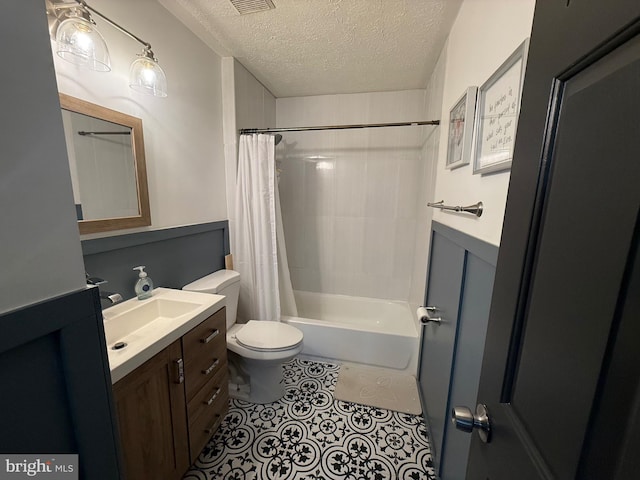 full bath with a textured ceiling, tile patterned flooring, toilet, vanity, and shower / tub combo with curtain