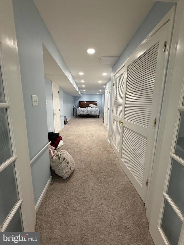 hallway with carpet floors, baseboards, and recessed lighting