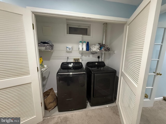 clothes washing area featuring visible vents, light carpet, and washer and clothes dryer