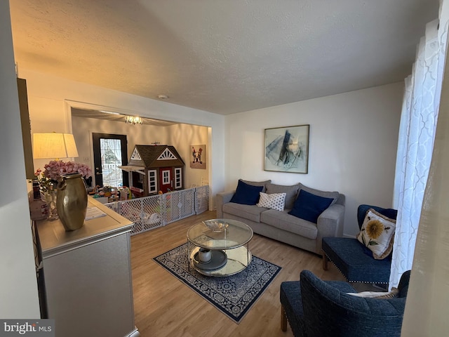 living room with a textured ceiling and wood finished floors