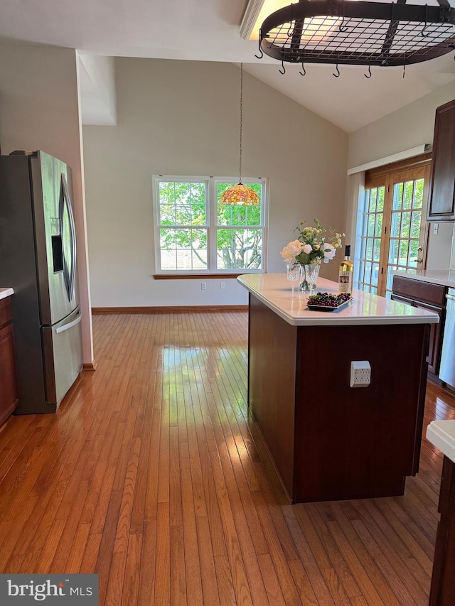 200 Stewards Ct, Bear, DE 19701 - kitchen with appliances with stainless steel finishes, vaulted ceiling, light countertops, light wood finished floors, and a kitchen island