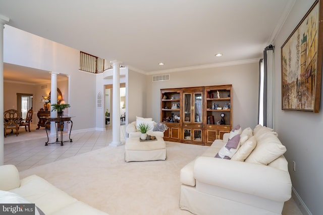 living room with light tile patterned floors, visible vents, baseboards, decorative columns, and crown molding