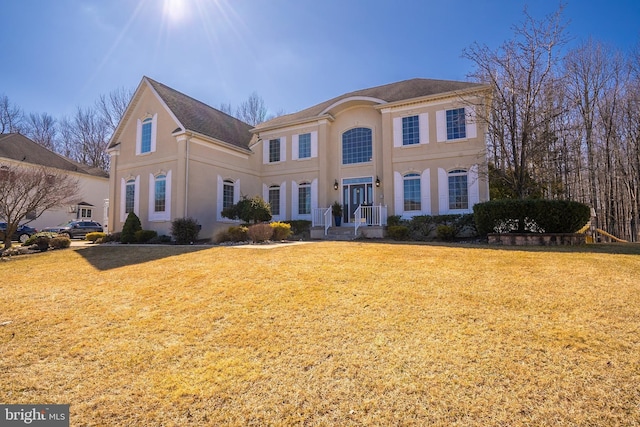 view of front facade featuring a front yard and stucco siding