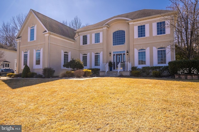 view of front of property featuring a front yard and stucco siding