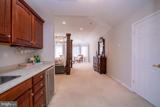 interior space featuring recessed lighting, light carpet, baseboards, and wine cooler