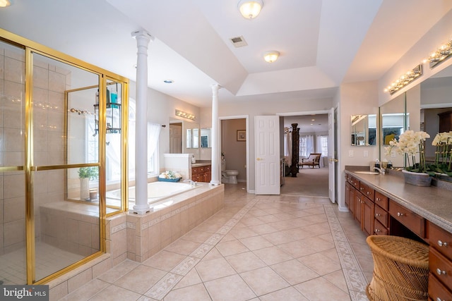 bathroom featuring a garden tub, toilet, tile patterned floors, a stall shower, and decorative columns