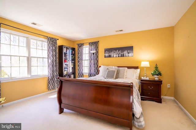 bedroom featuring carpet flooring, visible vents, and baseboards