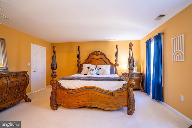 bedroom featuring baseboards, visible vents, and light colored carpet