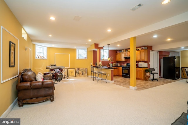 living room featuring light colored carpet, visible vents, and recessed lighting