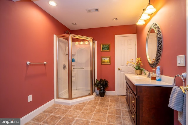 full bathroom featuring visible vents, vanity, a shower stall, tile patterned flooring, and baseboards