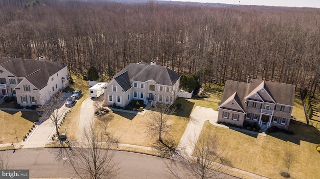 birds eye view of property featuring a view of trees