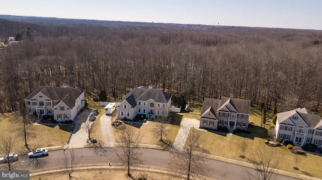 drone / aerial view featuring a forest view