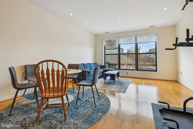 interior space with light wood-style flooring, baseboards, and recessed lighting