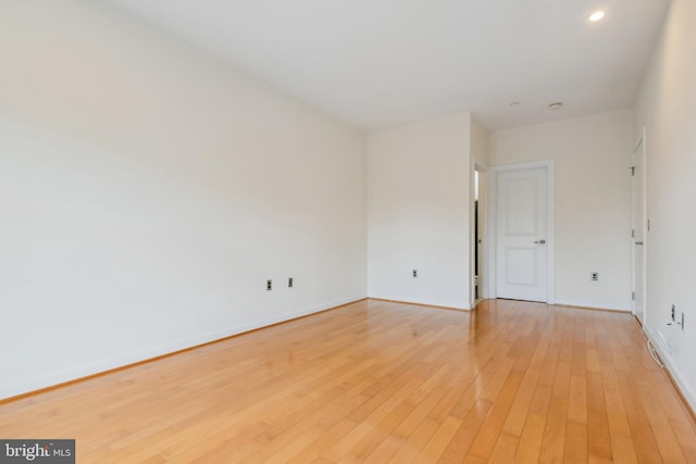 spare room with light wood-style flooring and baseboards