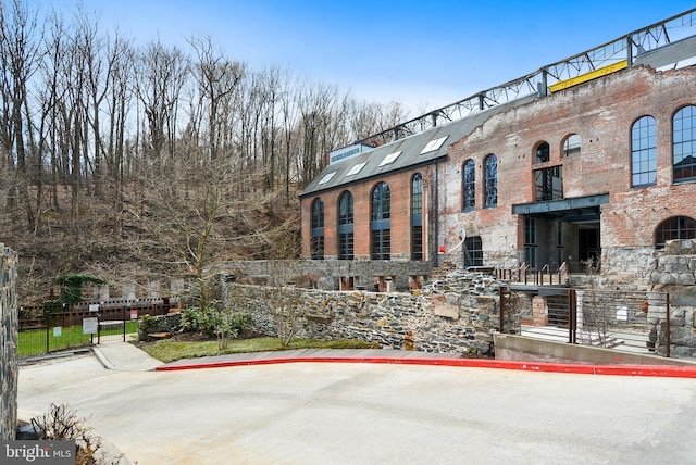 view of building exterior with fence