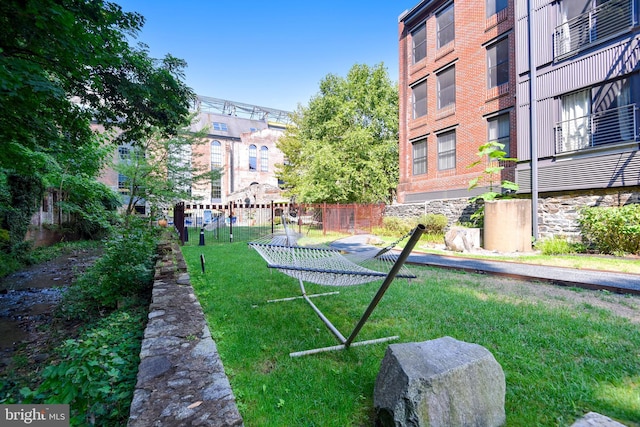 surrounding community with fence and a lawn