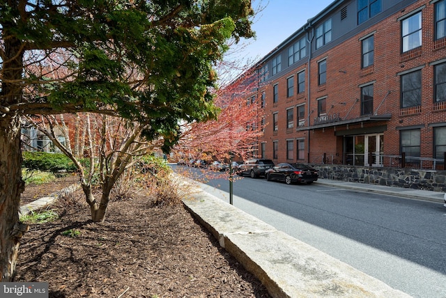 view of road with sidewalks and curbs