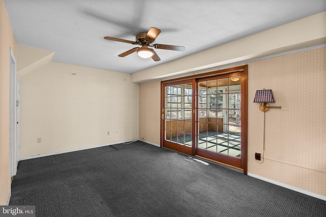 spare room featuring carpet, ceiling fan, baseboards, and wallpapered walls