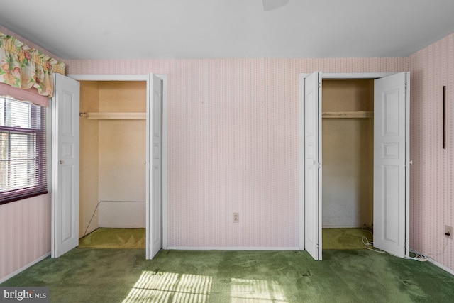 unfurnished bedroom featuring wallpapered walls and carpet