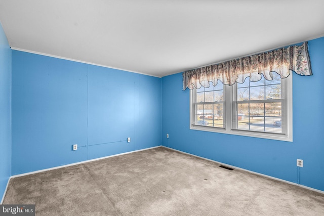 carpeted spare room with visible vents