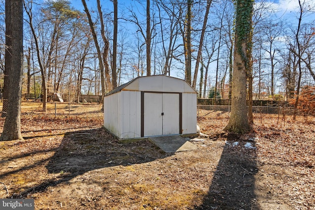 view of shed with fence