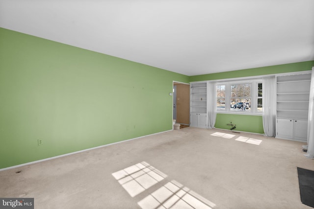 unfurnished bedroom with baseboards and light colored carpet