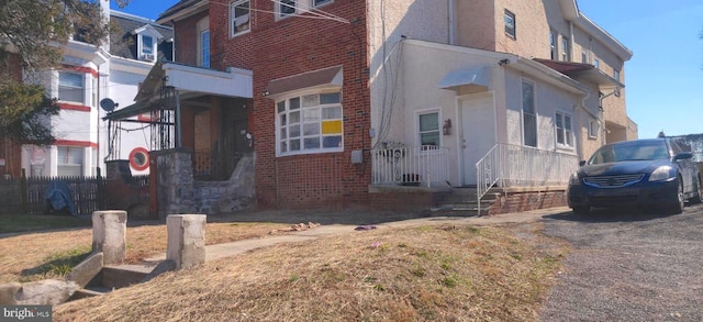 view of side of home with brick siding