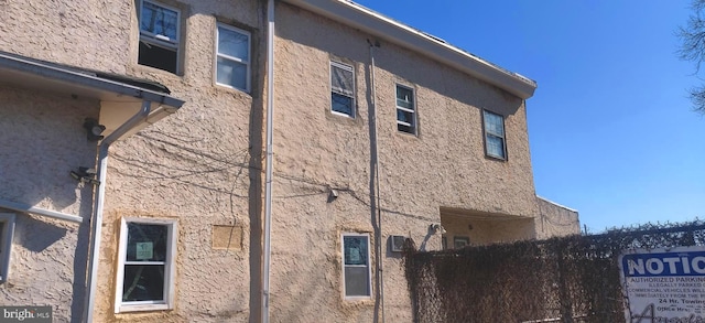 view of side of property featuring stucco siding