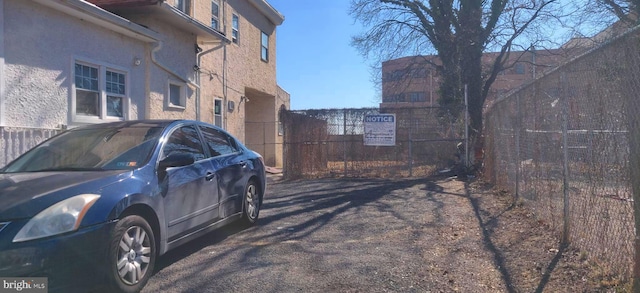 view of side of property featuring fence