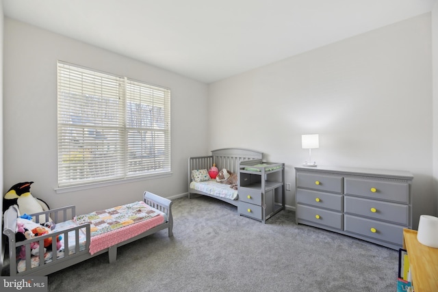 carpeted bedroom featuring baseboards