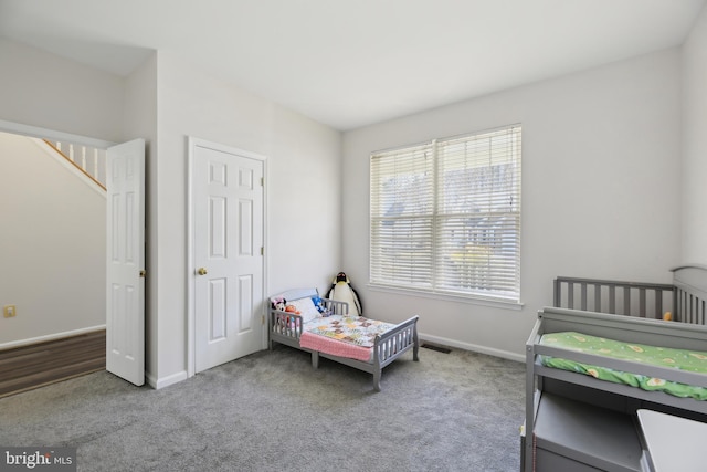 bedroom with carpet floors and baseboards