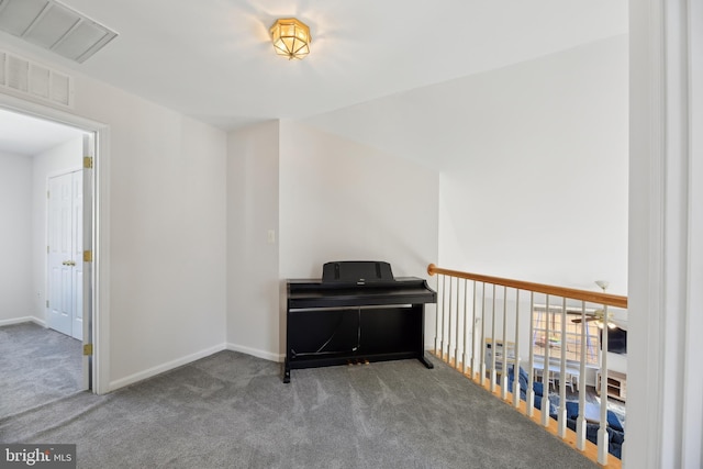 sitting room with carpet, visible vents, and baseboards