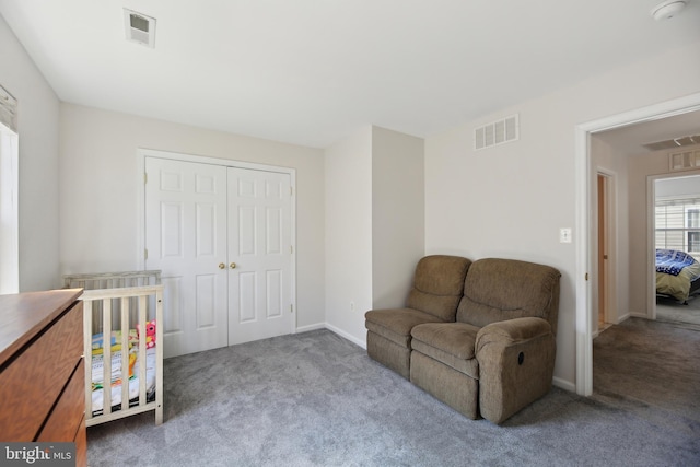 sitting room featuring baseboards, visible vents, and carpet flooring