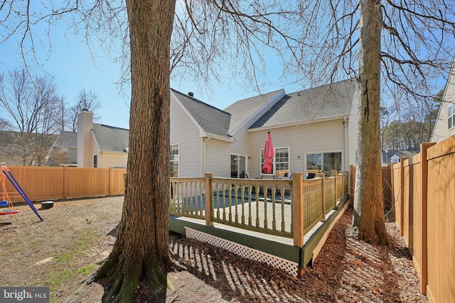 back of property featuring a deck and a fenced backyard