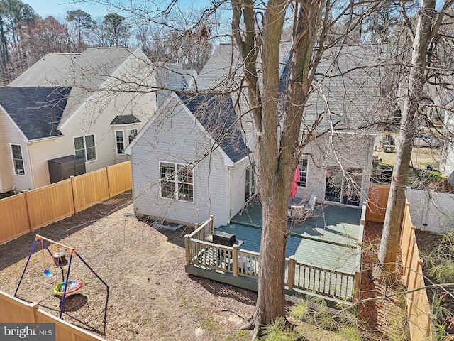 rear view of house featuring a fenced backyard and a wooden deck