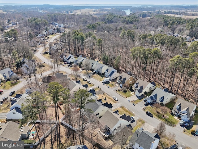 bird's eye view featuring a wooded view and a residential view