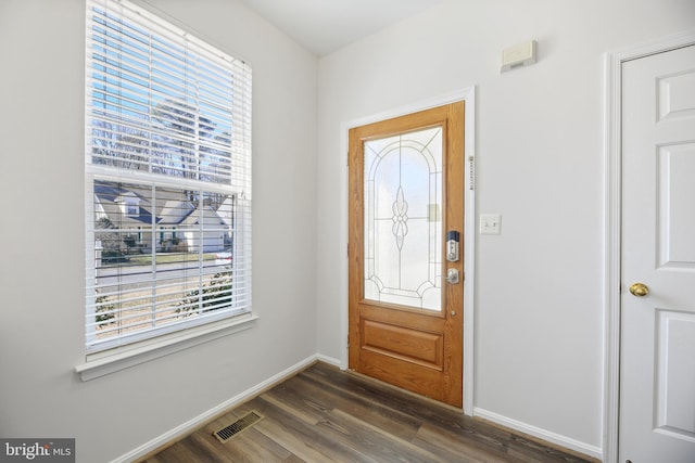 entrance foyer featuring dark wood finished floors, visible vents, plenty of natural light, and baseboards