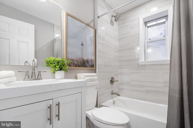 full bath with vanity, shower / bath combo with shower curtain, and toilet